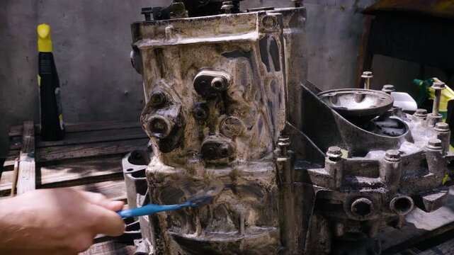 old gear shift box for front-wheel drive car cleaning from dirt with chemical agent and rinsing with water