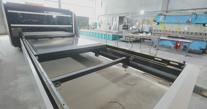 CNC Laser Machine Cutting Metal Parts in Workshop. CNC Laser Cutting Machine Processing Aluminum Sheet Metal. Metal processing and metal cutting workshop. Production site