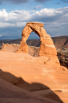 Sunset approaches, Delicate Arch, the most famous arch in Arches National Park in Moab, Utah. Warm light at Golden Hour as the sun sets on Delicate Arch, southern Utah national park.