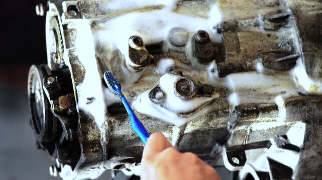 old gear shift box for front-wheel drive car cleaning from dirt with chemical agent and rinsing with water vertical video