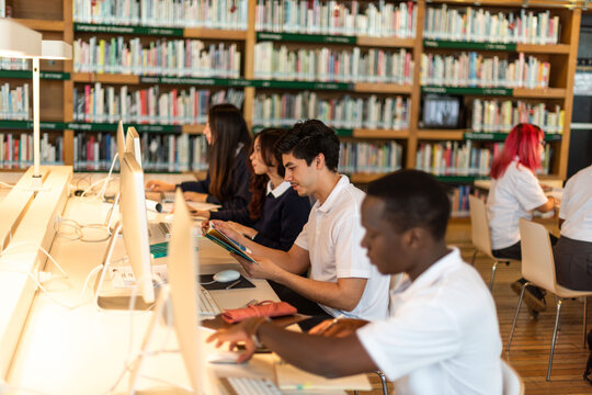 Students studying in modern library