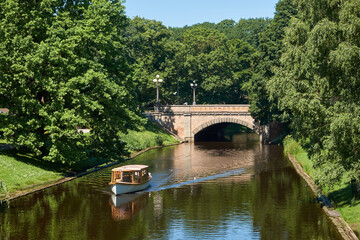 Fototapeta premium Small sightseeing boat on a City Canal in Riga, Latvia