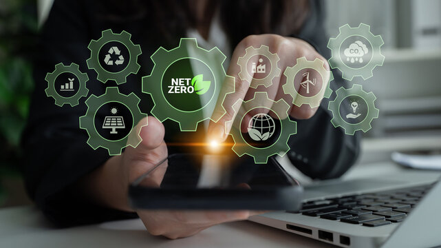Interconnected green gears with icons representing renewable energy, carbon reduction, recycling, and eco innovation working toward a net zero goal Parse
