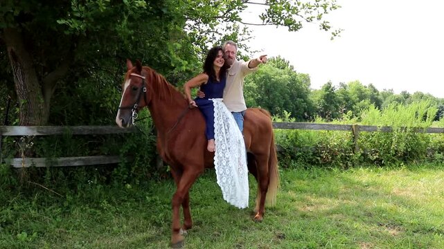 A couple enjoy a romantic ride on a playful horse