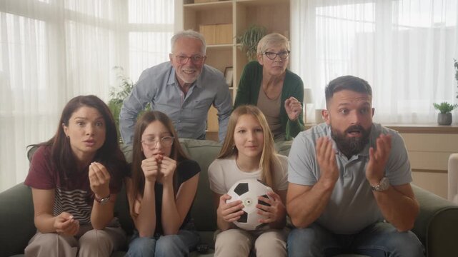 Frustrated Multi Generation Family Reacting to Missed Soccer Goal at Home