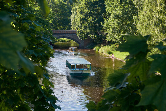 Small sightseeing boat on a Picturesque City Canal in summer Riga, Latvia