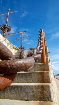 Rusty Chain Railing Along Stone Stairs