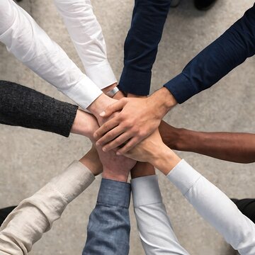 Diverse group of business people stacking their hands together in unity