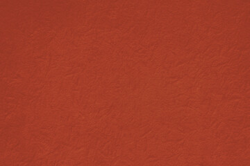 Fototapeta premium Textured red background with a subtle, fabric-like appearance.