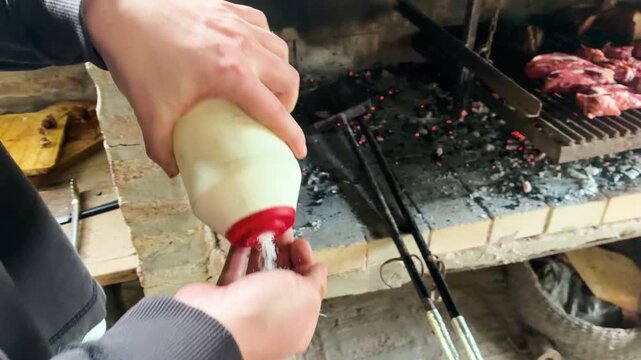 Authentic Argentine Asado &ndash; Close Up of Man Seasoning Raw Beef on Outoors Barbeque - Argentina