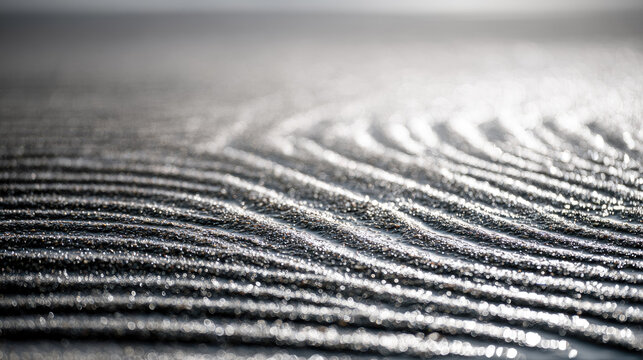 Wet mud coastal soil ripple pattern macro photography silt surface water pocket sand grain natural texture bright sunlight shallow depth