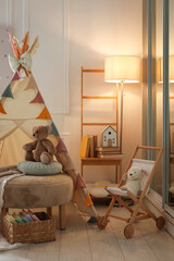 Beautiful wigwam, ottoman, different toys and books in child's room © New Africa
