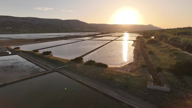 Aerial view of salt production basins in the Solana Pag area featuring geometric patterns and Mediterranean scenery