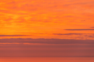 Fototapeta premium Beautiful orange sunset over the sea. Evening sea landscape