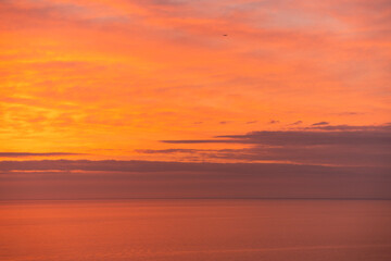 Fototapeta premium Beautiful orange sunset over the sea. Evening sea landscape