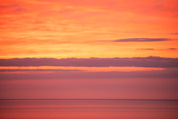 Fototapeta premium Beautiful orange sunset over the sea. Evening sea landscape