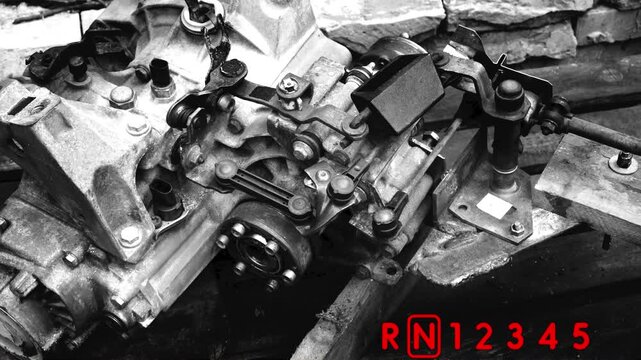 old gear shift box for a front-wheel drive car example of how to shift numbers and letters to understand how the mechanism works black and white video with red fonts