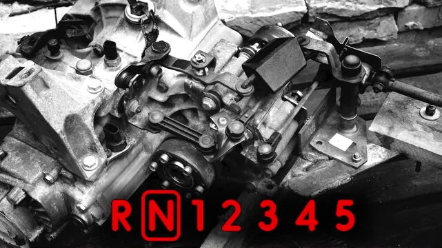 old gear shift box for a front-wheel drive car example of how to shift numbers and letters to understand how the mechanism works black and white video with red fonts