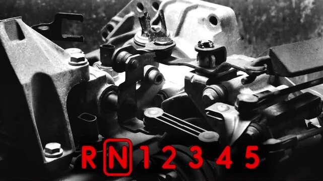 old gear shift box for a front-wheel drive car example of how to shift numbers and letters to understand how the mechanism works black and white video with red fonts