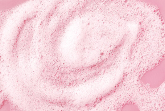 White skincare cleansing foam on light pink background