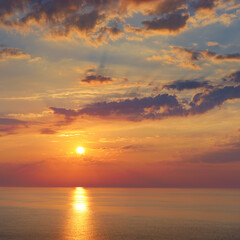 Obraz premium Colorful seascape with golden sunset and clouds at evening time, inspirational background for serenity
