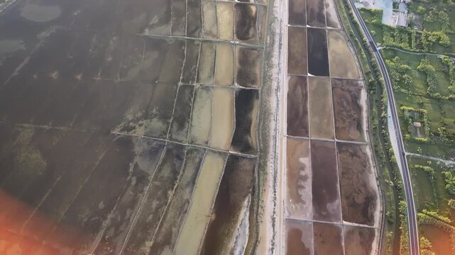 Drone footage of Pag saltworks with a coastal road and panoramic views across the island landscape and Adriatic surroundings