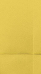 Fototapeta premium Bright textured yellow wallpaper for mobile