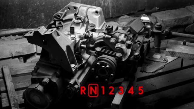 old gear shift box for a front-wheel drive car example of how to shift numbers and letters to understand how the mechanism works black and white video with red fonts