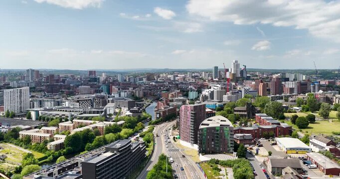 Panoramic aerial view of Leeds city centre and Leeds Dock with the River Aire modern office towers residential developments historic buildings and the evolving skyline of West Yorkshire