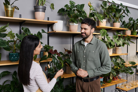 Professional florist engages with a male client in a vibrant, eco-friendly shop.