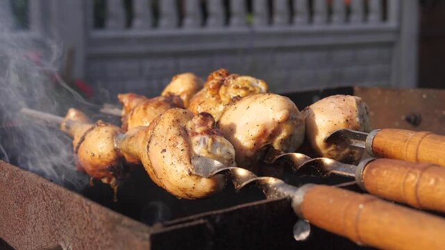 Chicken thighs are being grilled on the barbecue.