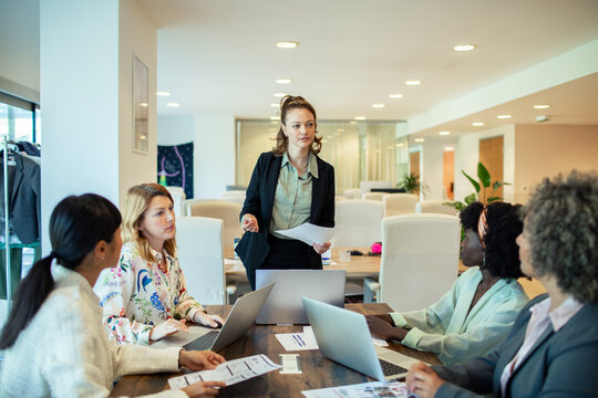 Female manager leading team meeting in modern office