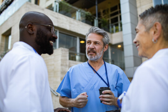 Healthcare professionals having conversation outside hospital