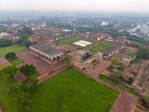 Aerial view of the historic Lahore Fort complex featuring Mughal architecture, expansive green lawns, and stone courtyards in Lahore, Punjab, Pakistan.