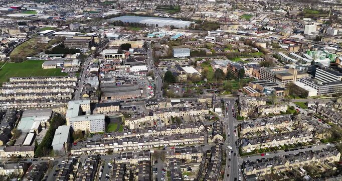 Aerial drone footage of the City of Bradford in Yorkshire in the UK showing the urban skyline historic architecture busy roads commercial districts residential areas and the wider Yorkshire landscape