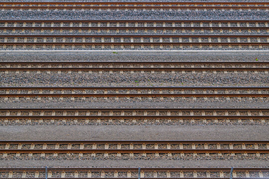 Parallel railway tracks forming geometric transport pattern on gravel ballast.