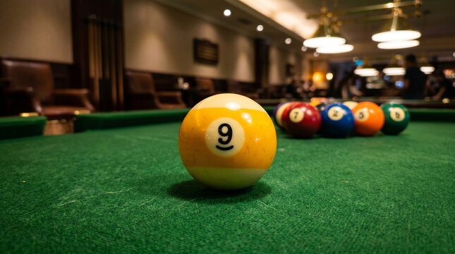 Close-up of Yellow 9 Ball on a Green Billiard Table