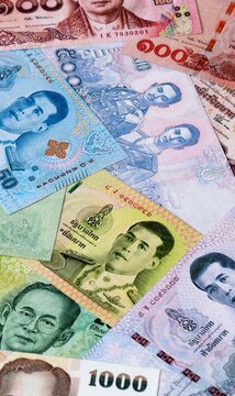 Thai baht money bills in pile on table. Thailand THB currency cash close up