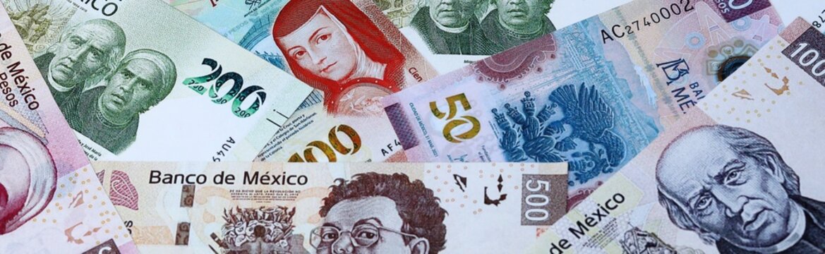 Mexican peso money bills in pile on table. Mexico MXN currency cash close up