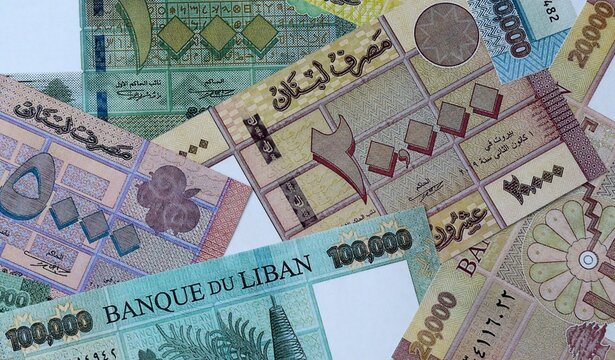 Lebanese pound money bills in pile on table. Lebanon LBP currency cash close up