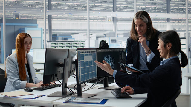 Engineering team doing semiconductors prototyping with artificial intelligence in office, camera A.