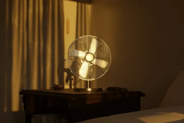 3d rendering of an electric fan in the evening sunlight. Concept tropical heat © Brilliant Eye