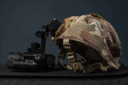 Tactical night vision gear set featuring monocular device with bracket mount and multicam skull cap on dark background