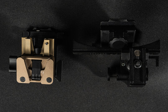 Two different types of tactical night vision device mounts featuring dovetail interface and mini rail adapter on dark background
