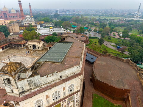 Aerial view of Lahore Fort featuring historic Mughal architecture, stone walls, and surrounding gardens in Lahore, Punjab, Pakistan.