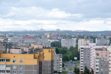 Fototapeta premium City panoramic view with residential multi story apartment buildings and industrial construction site in the background