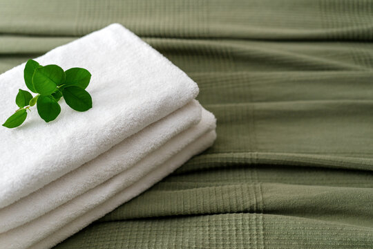 White towels folded on a bed in a hotel room for a comfortable stay