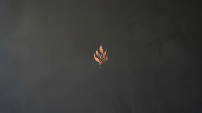 Minimalist Copper Leaf Emblem on Dark Textured Wall