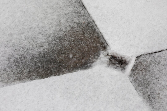 A backyard drain in the snow and sleet in early January, England, United Kingdom