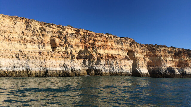 Golden limestone cliffs along the Algarve coastline